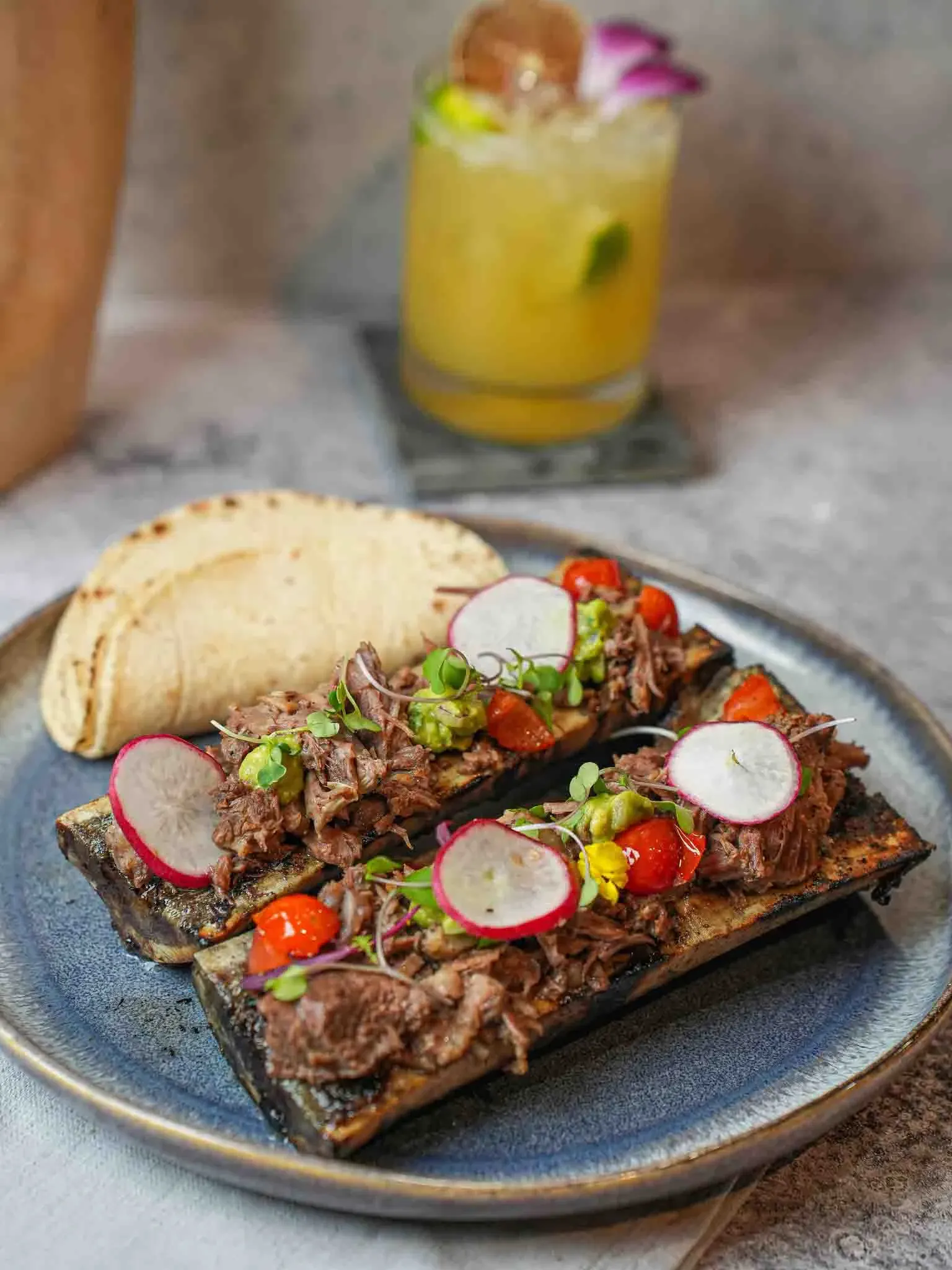 Tacos de tuétano with radish, tomato and fresh tortillas