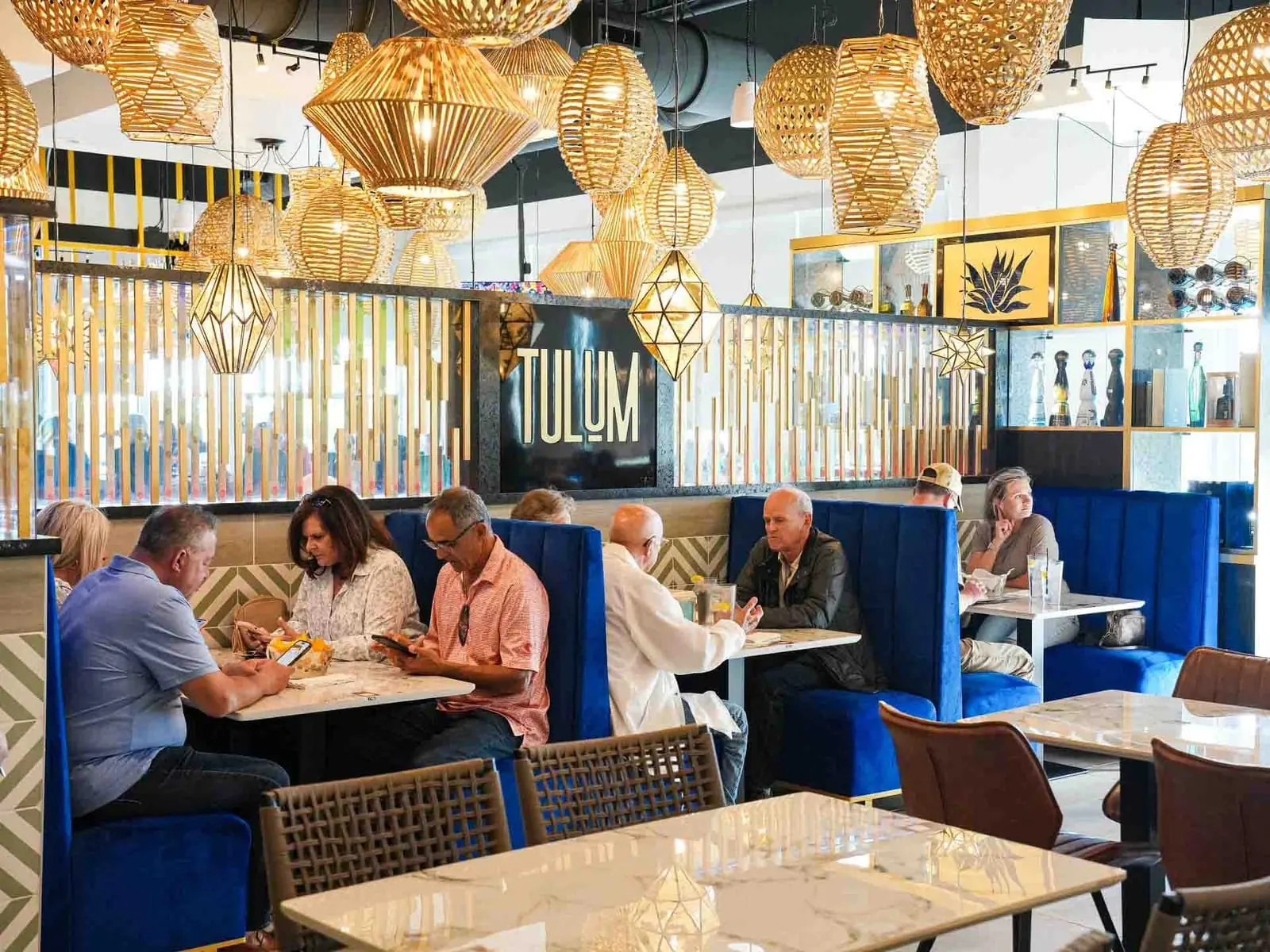 Guests dining under woven lanterns at Tulum Flavors of Mexico