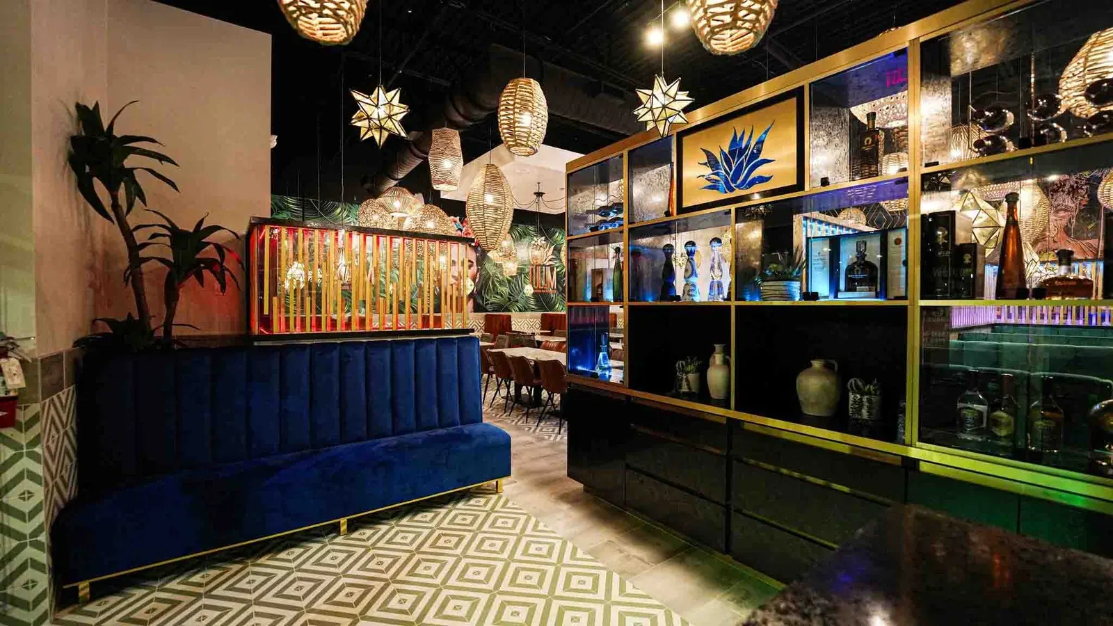 Blue velvet booths and the back bar at Tulum Flavors of Mexico