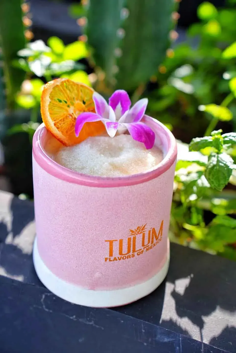A frozen cocktail in a pink Tulum cup